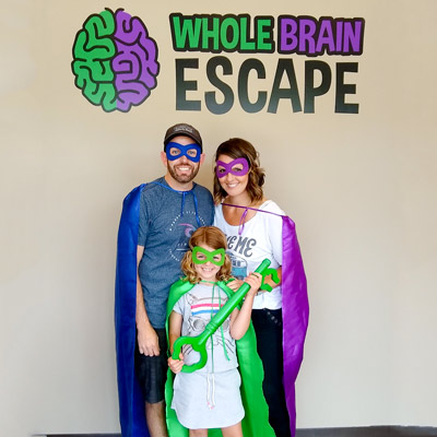 Mom, Dad and child out for Sunday Escape Room Fun at Whole Brain Escape.